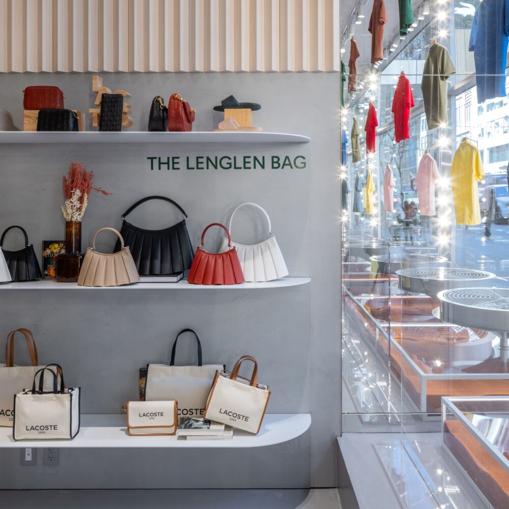 Interior of Lacoste Flagship Store, Fifth Avenue, New York, showcasing handbags and window displays illuminated with Zeplinn’s architectural lighting.