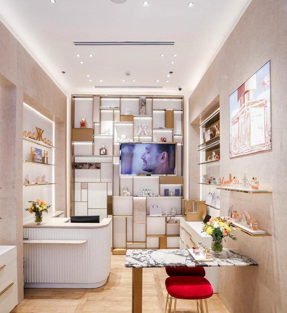 Checkout area of Maison Francis Kurkdjian boutique at Adora Greenbelt, Manila, with a well-lit and decorated back wall by Zeplinn’s architectural lighting.