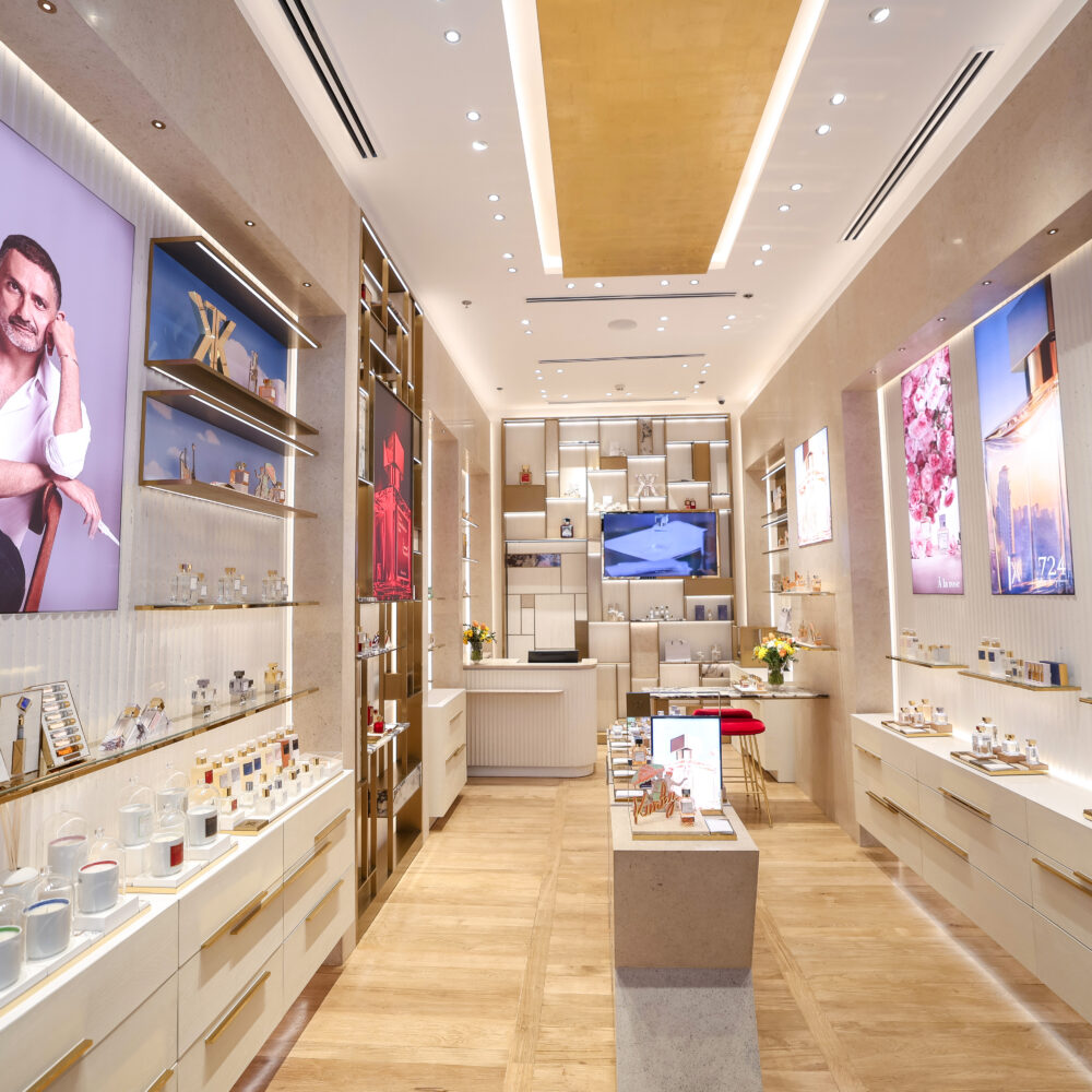Corridor inside Maison Francis Kurkdjian boutique at Adora Greenbelt, Manila, with a screen showing the founder, illuminated by Zeplinn’s architectural lighting.