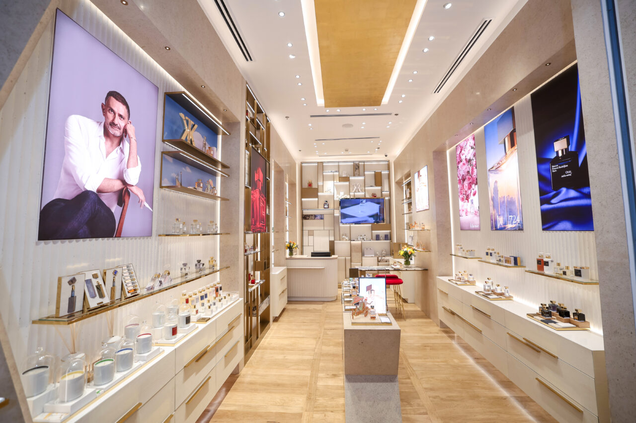 Corridor inside Maison Francis Kurkdjian boutique at Adora Greenbelt, Manila, with a screen showing the founder, illuminated by Zeplinn’s architectural lighting.