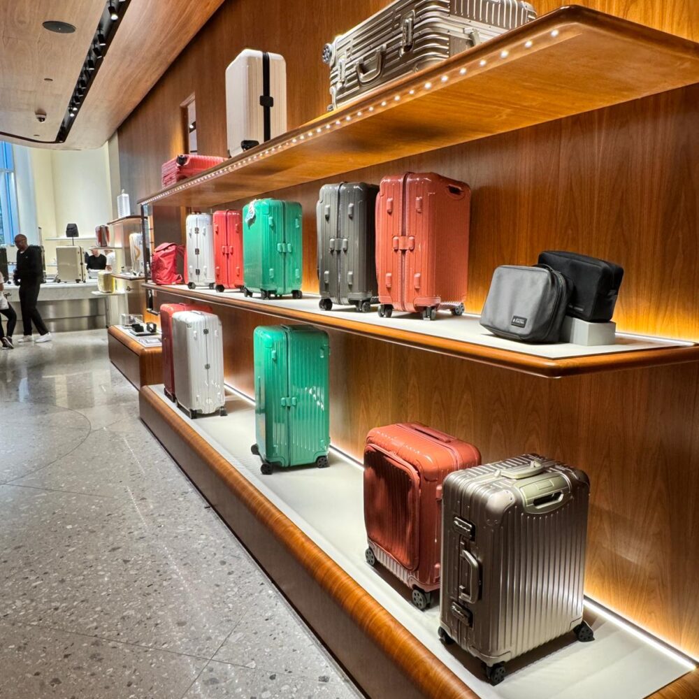 RIMOWA New York 5th Avenue store with long wooden shelves illuminated by Zeplinn architectural lighting