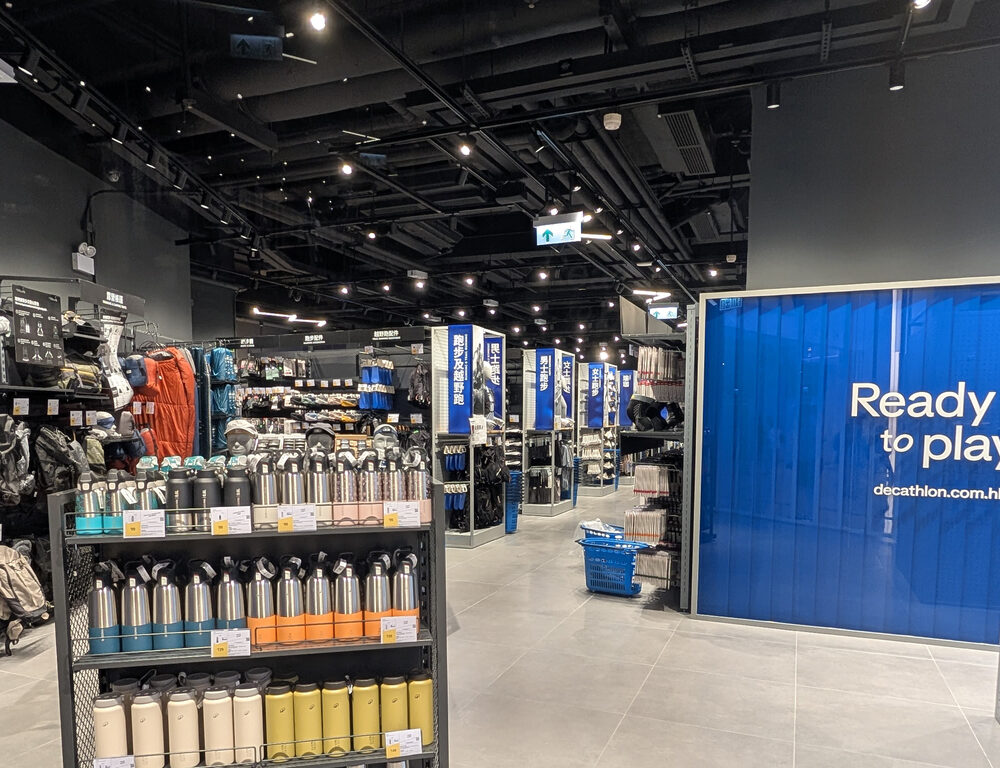 Checkout and central aisle of Decathlon YOHO Mall Hong Kong store lit by Zeplinn architectural lighting