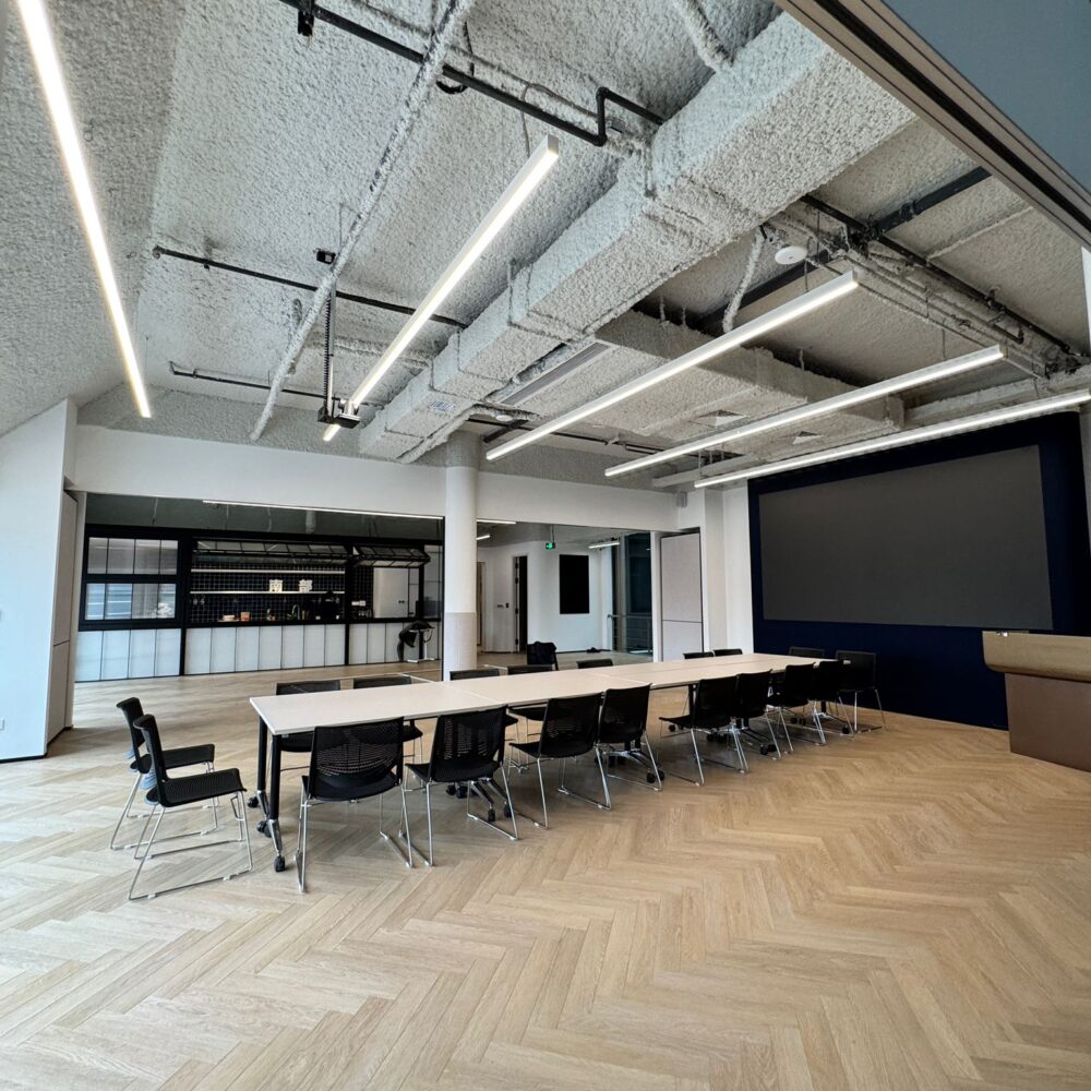 Meeting area with long table at French Chamber of Commerce Shanghai lit by Zeplinn architectural lighting