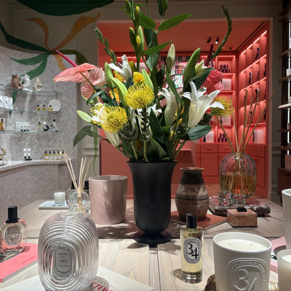 Central product table in Diptyque Miami Brickell store lit by Zeplinn architectural lighting