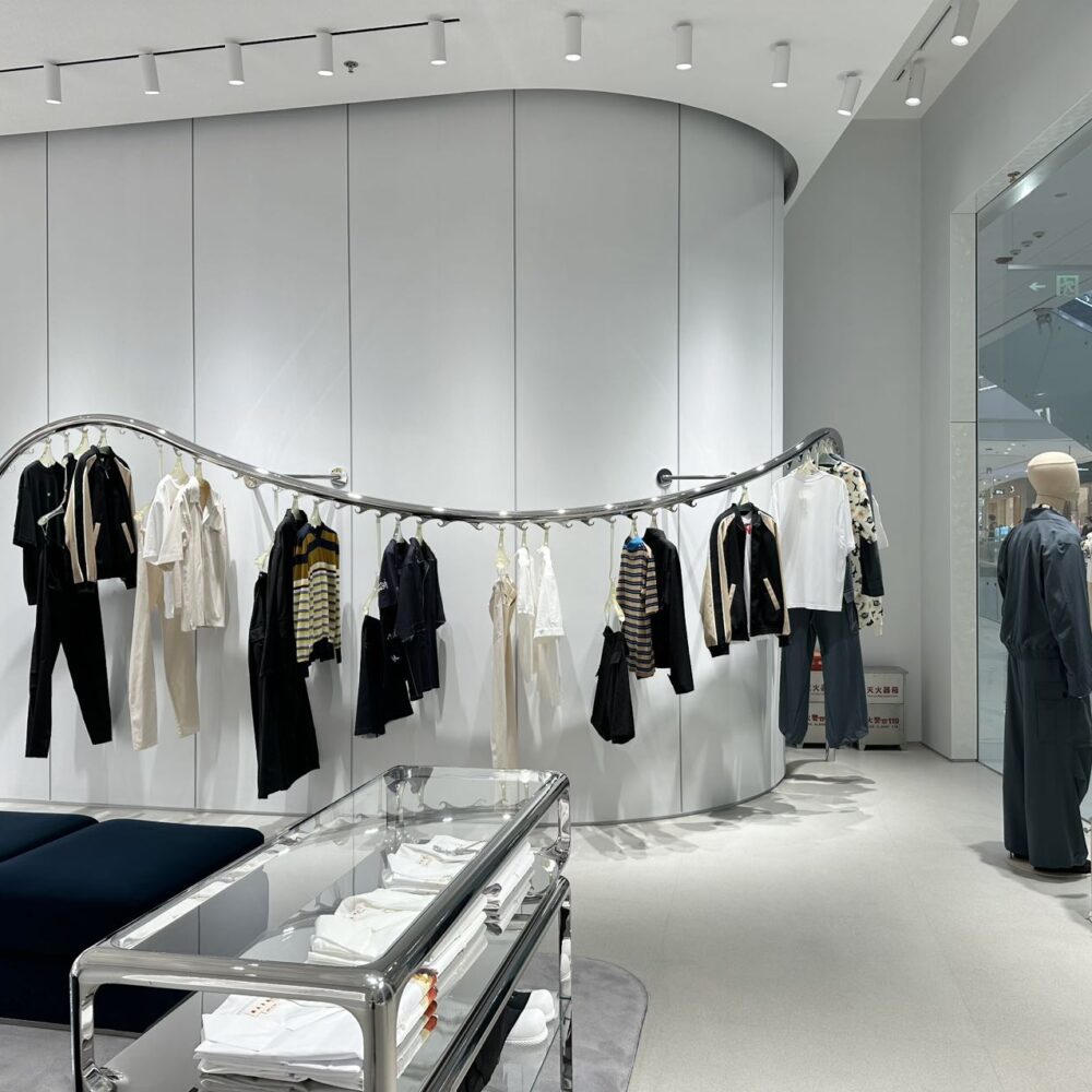 Marni Changsha boutique round corner featuring clothes on a signature metallic wavy hanger under Zeplinn’s precision retail lighting.