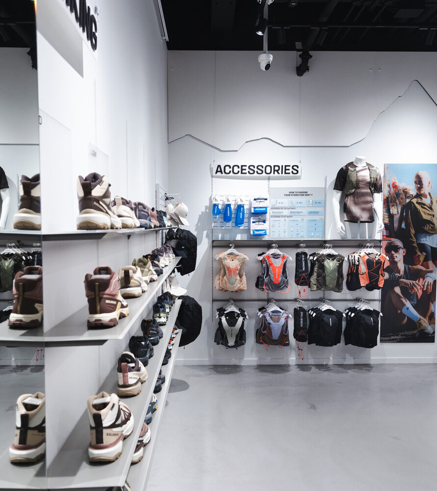 Salomon Battersea store corner with shoes on illuminated shelves under Zeplinn precision retail lighting.