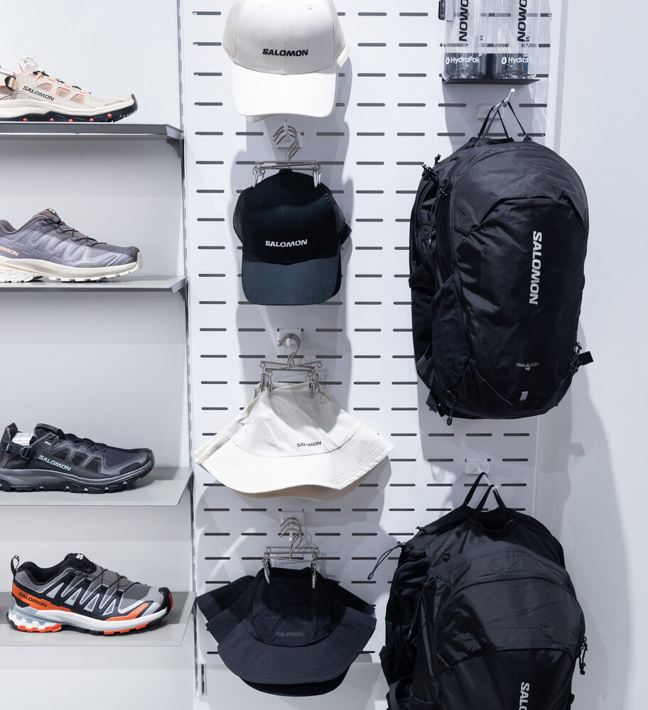 Salomon Battersea hanging display of bags, hats, and shoes, enhanced by Zeplinn layered lighting.